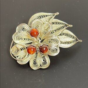 Silver toned and Brown Floral Filigree Costume jewelryBrooch with Vibrant Center